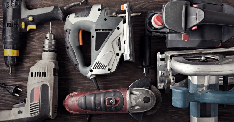 Different types of power tools on a workbench.